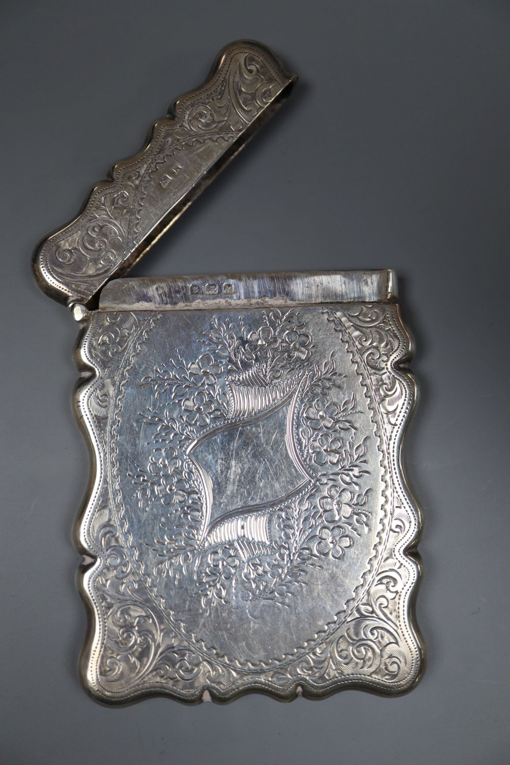 An Edwardian engraved silver card case, Birmingham, 1909, 94mm.